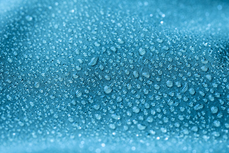 drops of water on blue textile background