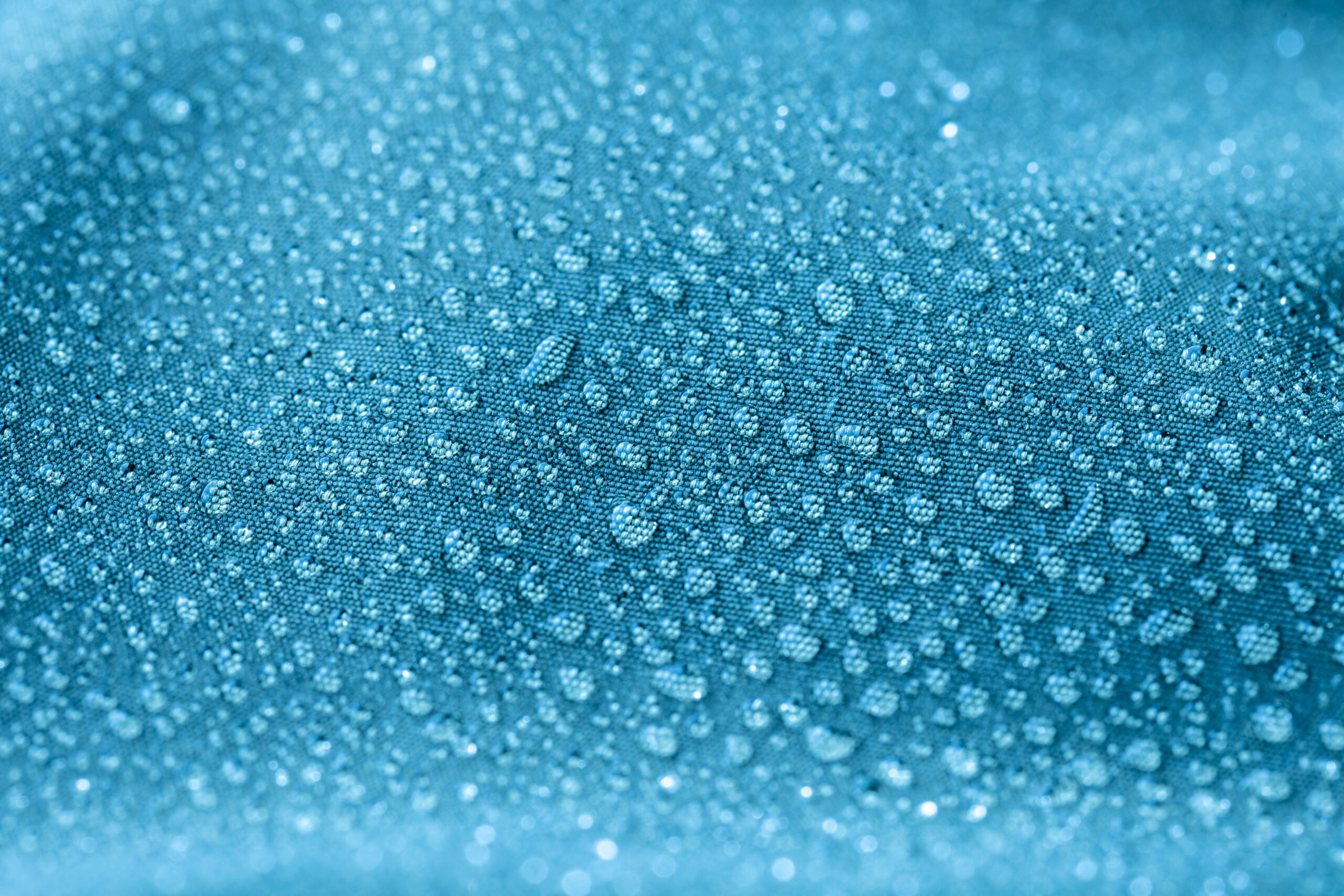drops of water on blue textile background