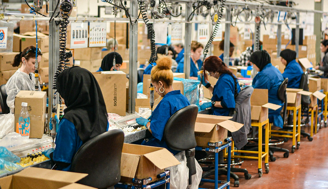 people sitting at sewing factory